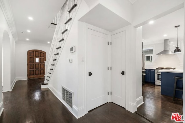 hall with dark hardwood / wood-style floors and crown molding