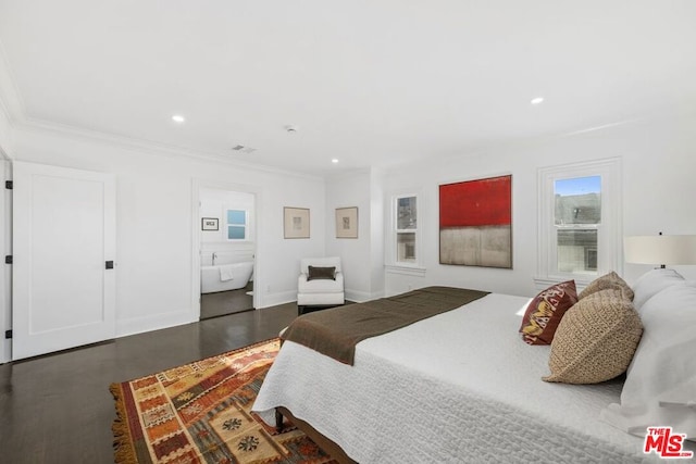 bedroom featuring ornamental molding, dark hardwood / wood-style floors, and ensuite bath