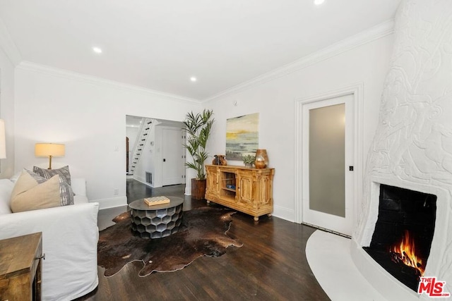 living room featuring hardwood / wood-style flooring and ornamental molding