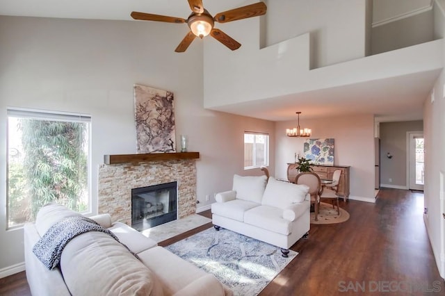 living room featuring dark hardwood / wood-style floors, a towering ceiling, and a healthy amount of sunlight