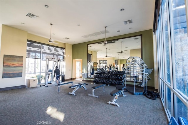 gym with ceiling fan and carpet floors