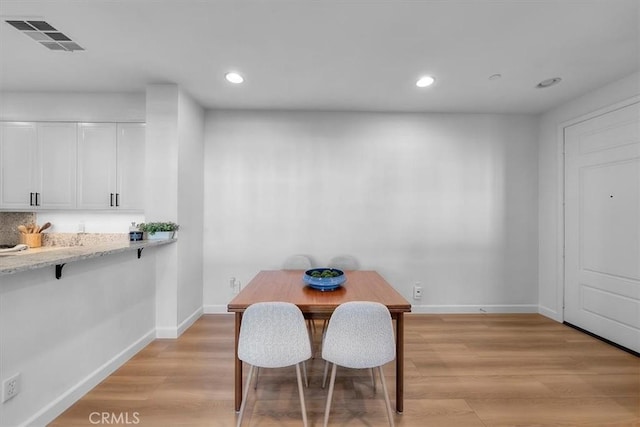 dining space featuring light wood-type flooring