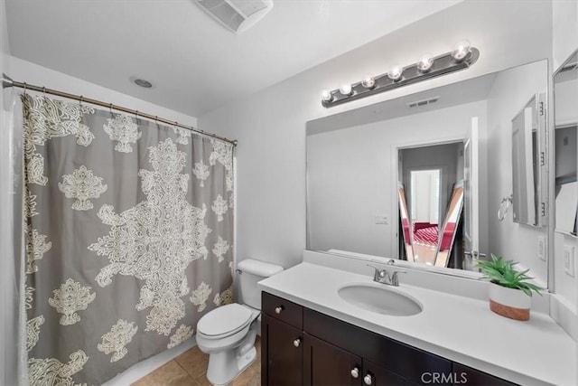 bathroom featuring tile patterned floors, toilet, and vanity