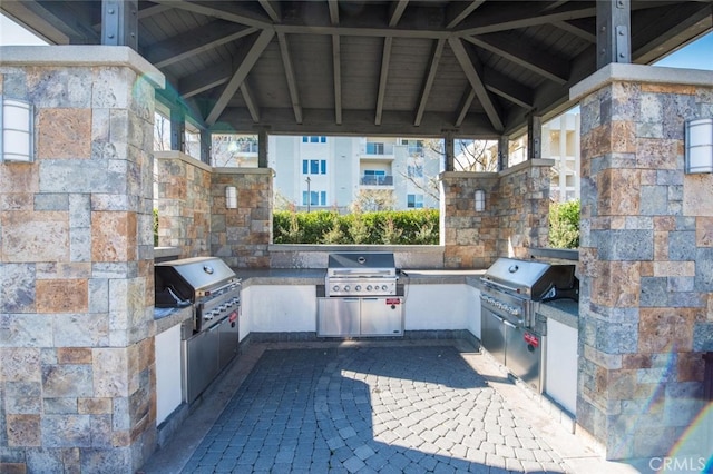 view of patio with an outdoor kitchen and grilling area