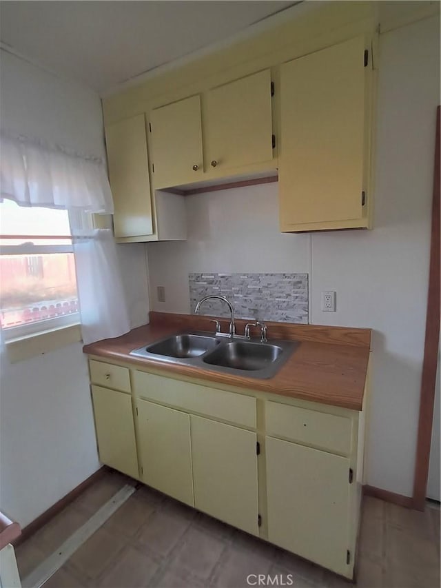 kitchen with sink and cream cabinets