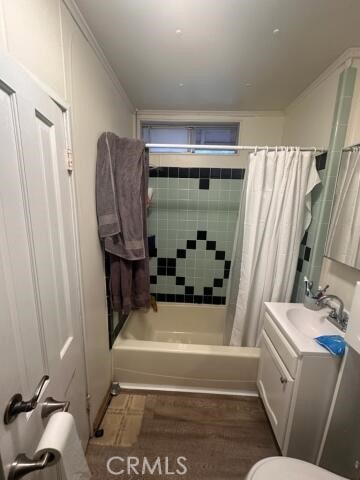 full bathroom with toilet, shower / bath combination with curtain, and vanity