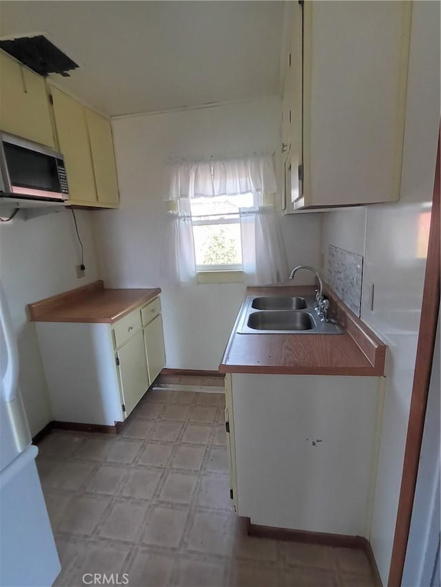 kitchen with sink and cream cabinets