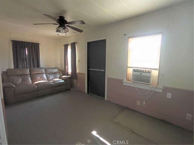 living room featuring a healthy amount of sunlight, cooling unit, and ceiling fan