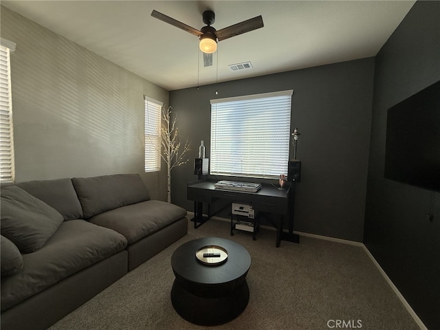 carpeted living room with ceiling fan