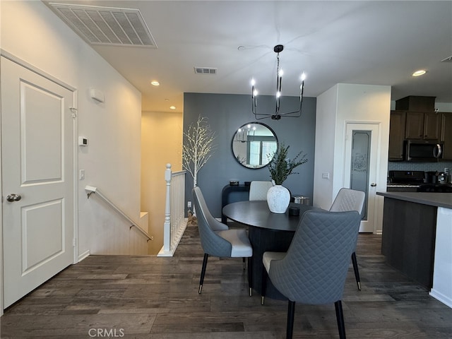 dining room featuring dark hardwood / wood-style flooring and an inviting chandelier