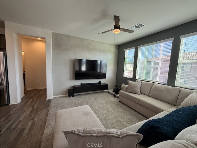 living room featuring wood-type flooring and ceiling fan