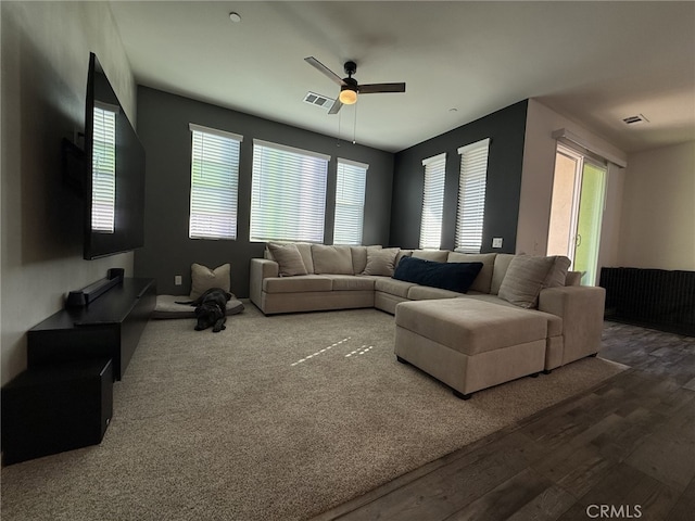 living room with wood-type flooring and ceiling fan