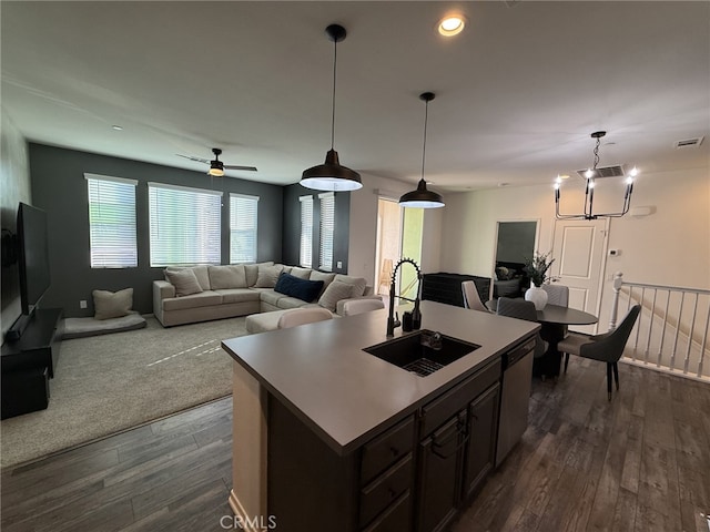 kitchen with sink, a center island with sink, dark hardwood / wood-style floors, and dishwasher