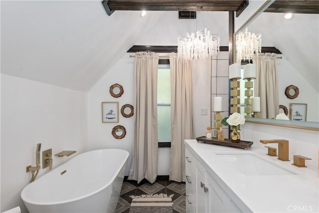 bathroom featuring vanity, a bathtub, an inviting chandelier, and lofted ceiling