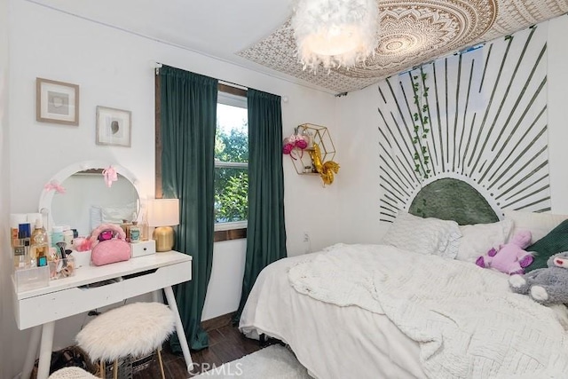 bedroom featuring a chandelier and dark hardwood / wood-style floors