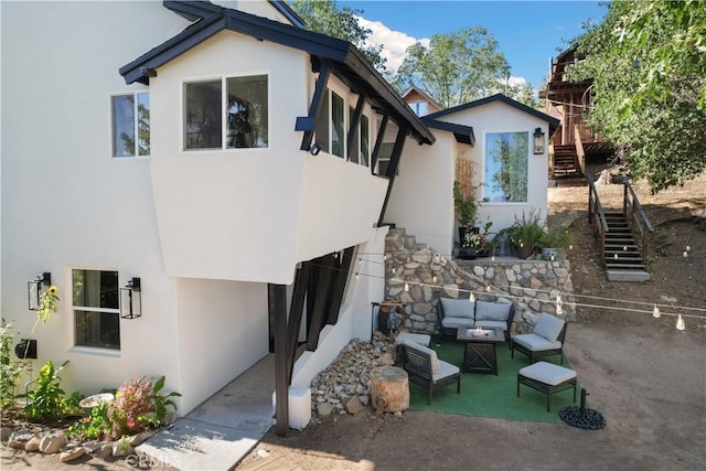 rear view of house with a patio area and outdoor lounge area