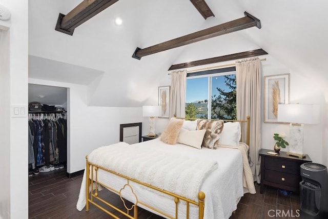 bedroom featuring lofted ceiling with beams, a closet, ceiling fan, and a walk in closet