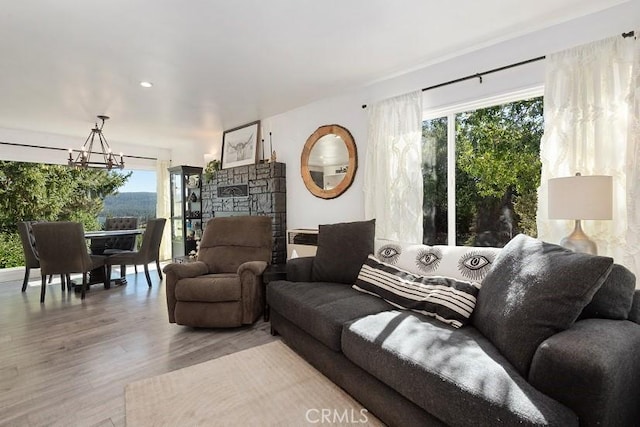 living room with hardwood / wood-style floors and a notable chandelier