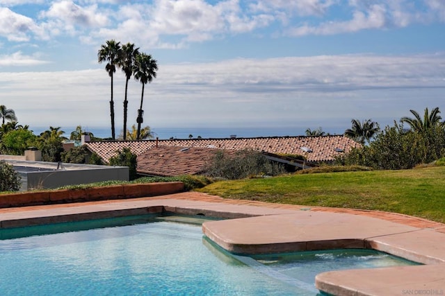 view of pool with a yard