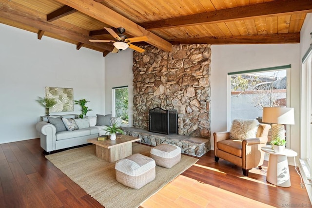 living room featuring hardwood / wood-style floors, beam ceiling, high vaulted ceiling, a fireplace, and wooden ceiling