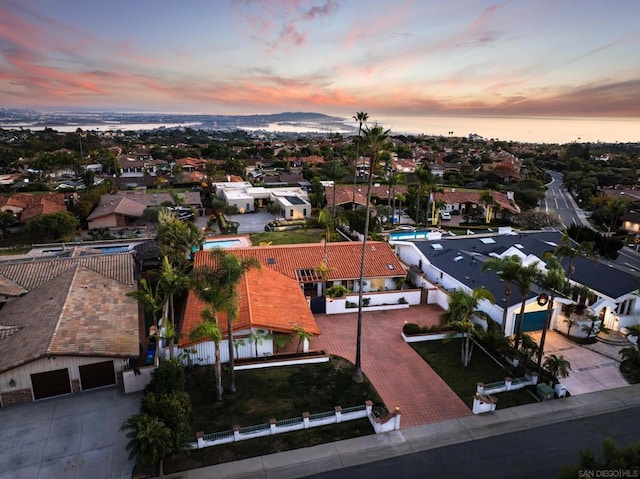 aerial view at dusk with a water view