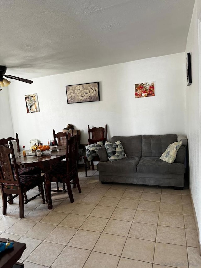 tiled living room featuring a textured ceiling and ceiling fan