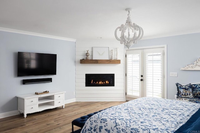 bedroom featuring a chandelier, ornamental molding, and hardwood / wood-style floors