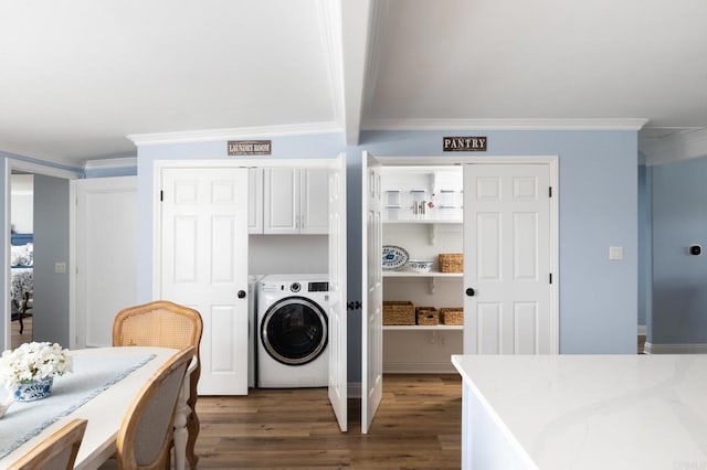 washroom with dark hardwood / wood-style flooring, cabinets, washer / dryer, and crown molding