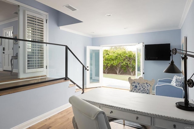 office space featuring light hardwood / wood-style flooring and crown molding