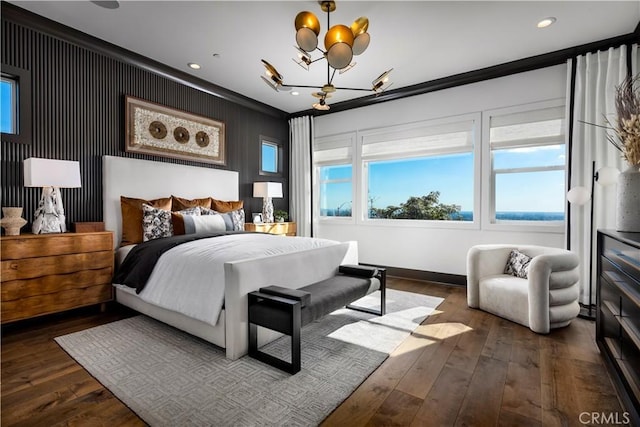 bedroom with crown molding, dark wood-type flooring, and a chandelier