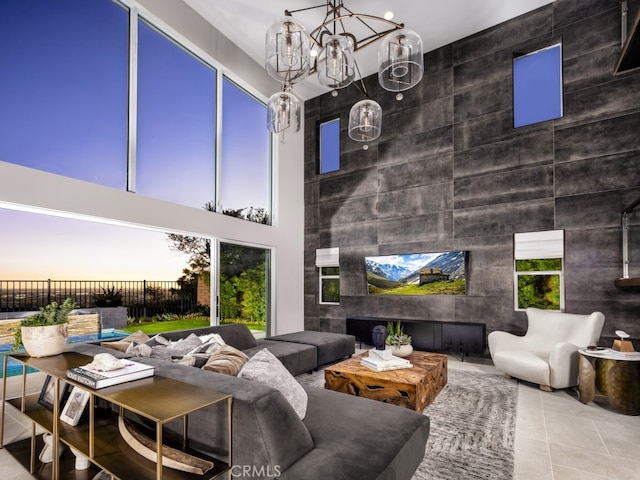 living room featuring an inviting chandelier and a towering ceiling