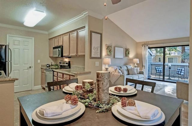 dining room with crown molding, vaulted ceiling, and ceiling fan