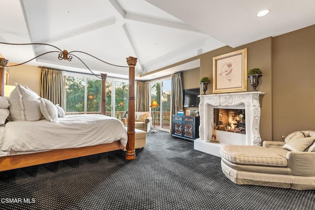 bedroom featuring access to outside, carpet floors, lofted ceiling, and a fireplace