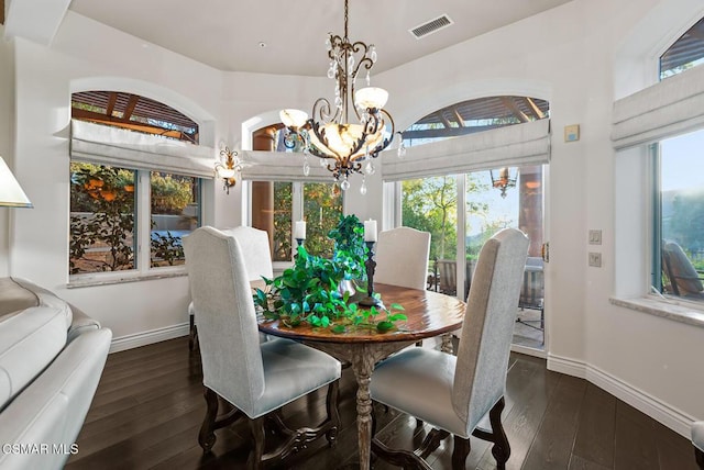 dining area with an inviting chandelier and dark hardwood / wood-style flooring