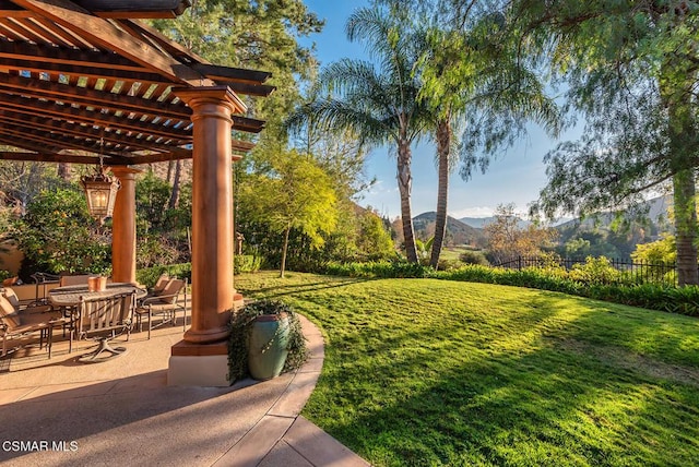 view of yard with a mountain view, a patio, and a pergola