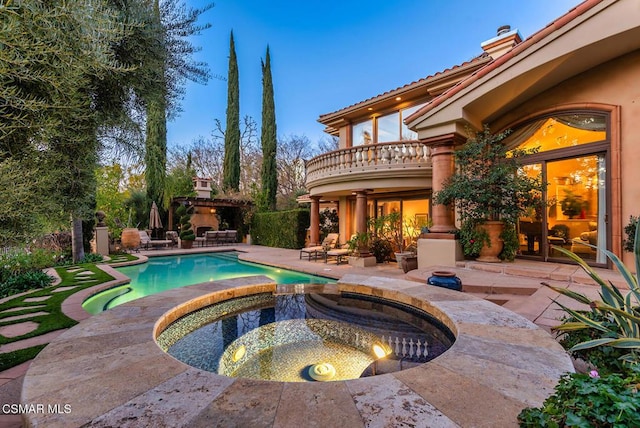 view of pool with an in ground hot tub and a patio area