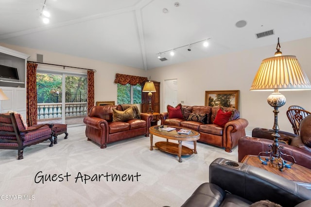 living room featuring light colored carpet, rail lighting, and lofted ceiling