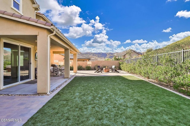 view of yard with a mountain view and a patio area