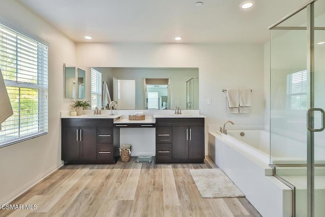 bathroom with independent shower and bath, vanity, and hardwood / wood-style flooring