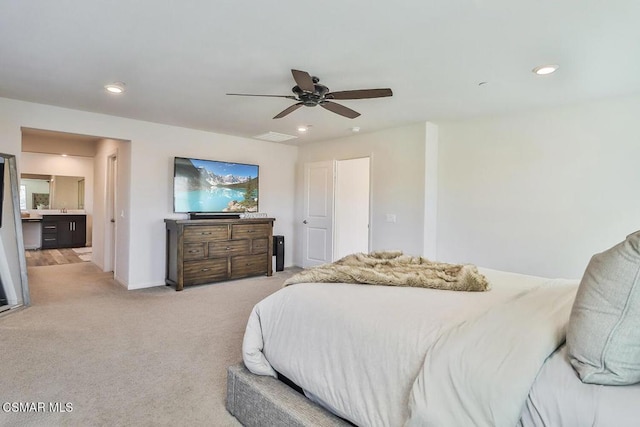 carpeted bedroom with ceiling fan and connected bathroom