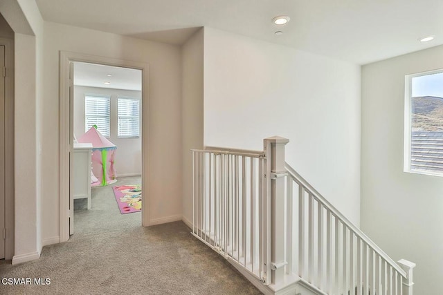 hallway with light colored carpet