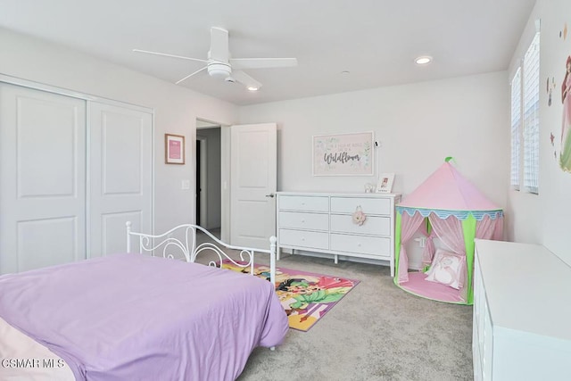 carpeted bedroom featuring a closet and ceiling fan