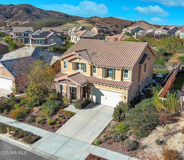 view of front of house featuring a garage and a mountain view