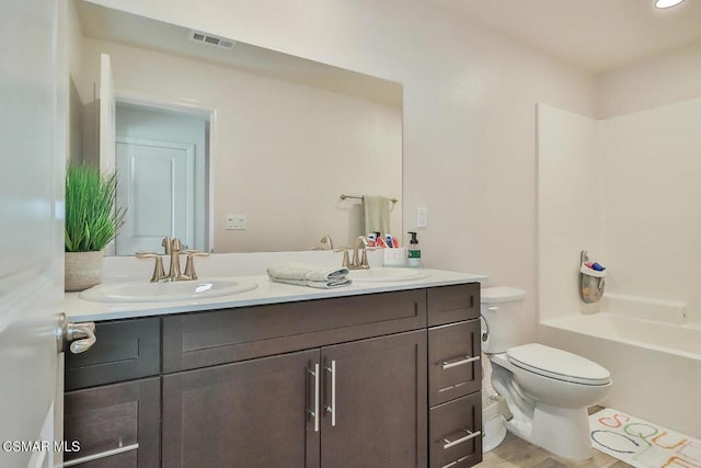 full bathroom with vanity, shower / bathtub combination, and toilet