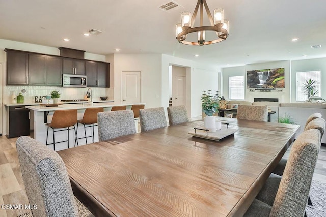 dining area featuring a notable chandelier and light hardwood / wood-style floors