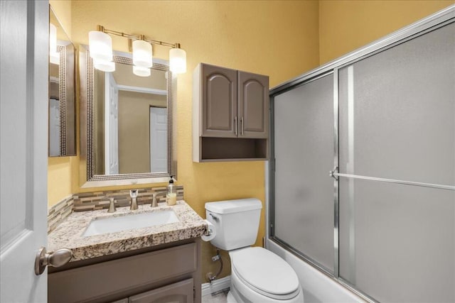 full bathroom with toilet, enclosed tub / shower combo, and vanity