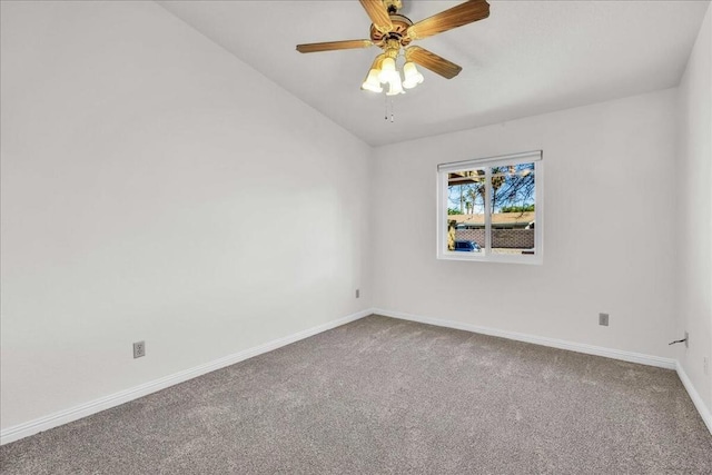 carpeted empty room featuring ceiling fan and vaulted ceiling