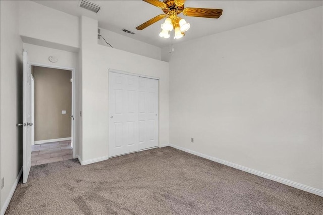 unfurnished bedroom with carpet floors, a closet, and ceiling fan