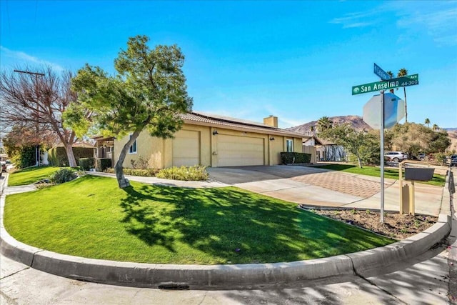 view of front of home featuring a garage and a front lawn