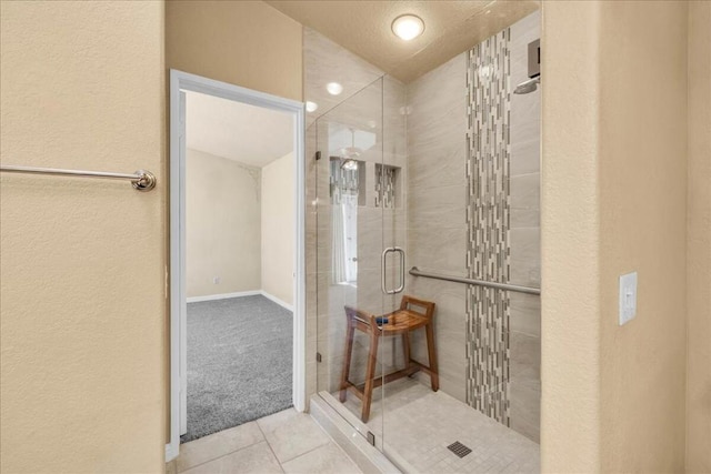 bathroom featuring a shower with shower door and tile patterned flooring